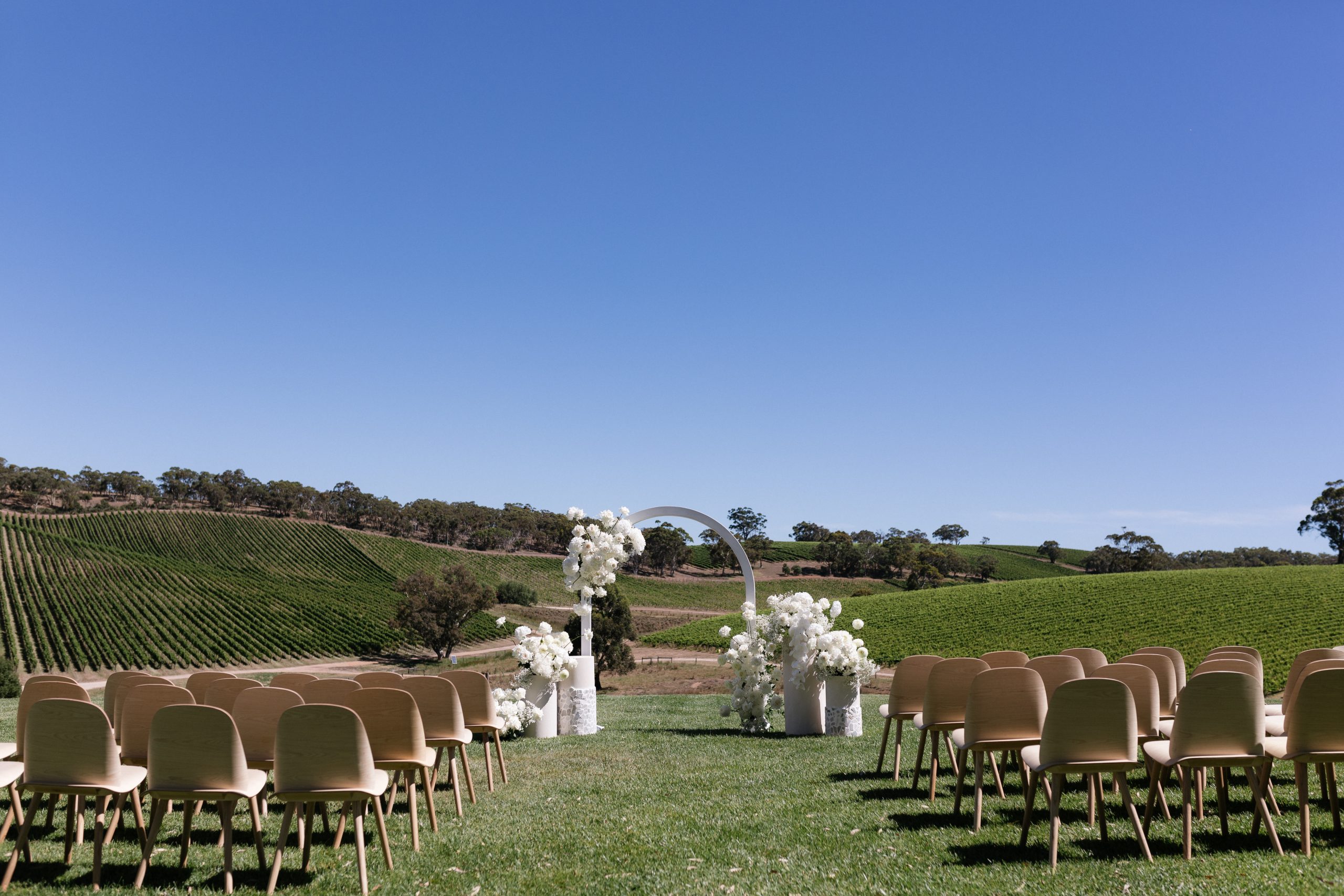 The modern approach white arch wedding arbor, Jack Small Photography