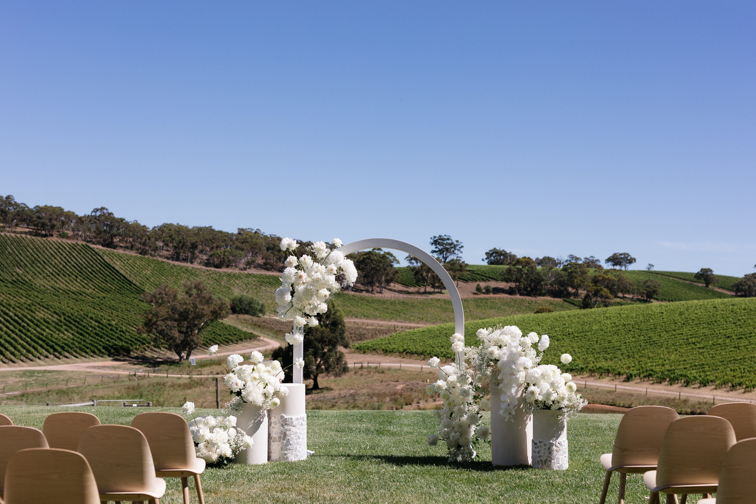 The modern approach white arch wedding arbor, Jack Small Photography