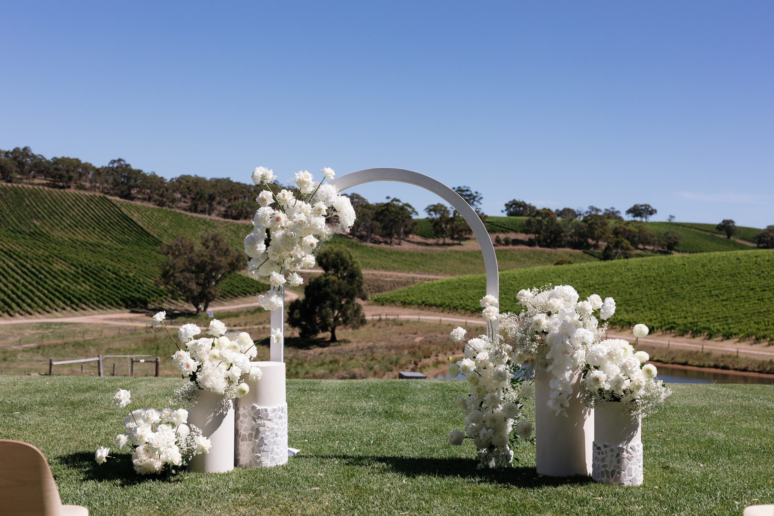 The modern approach white arch wedding arbor, Jack Small Photography