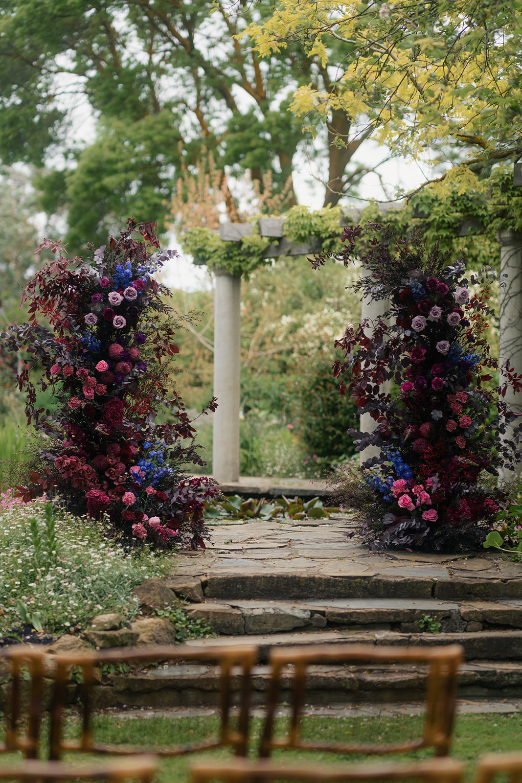 Wedding Arbour made with florals that create a moody rustic elegance