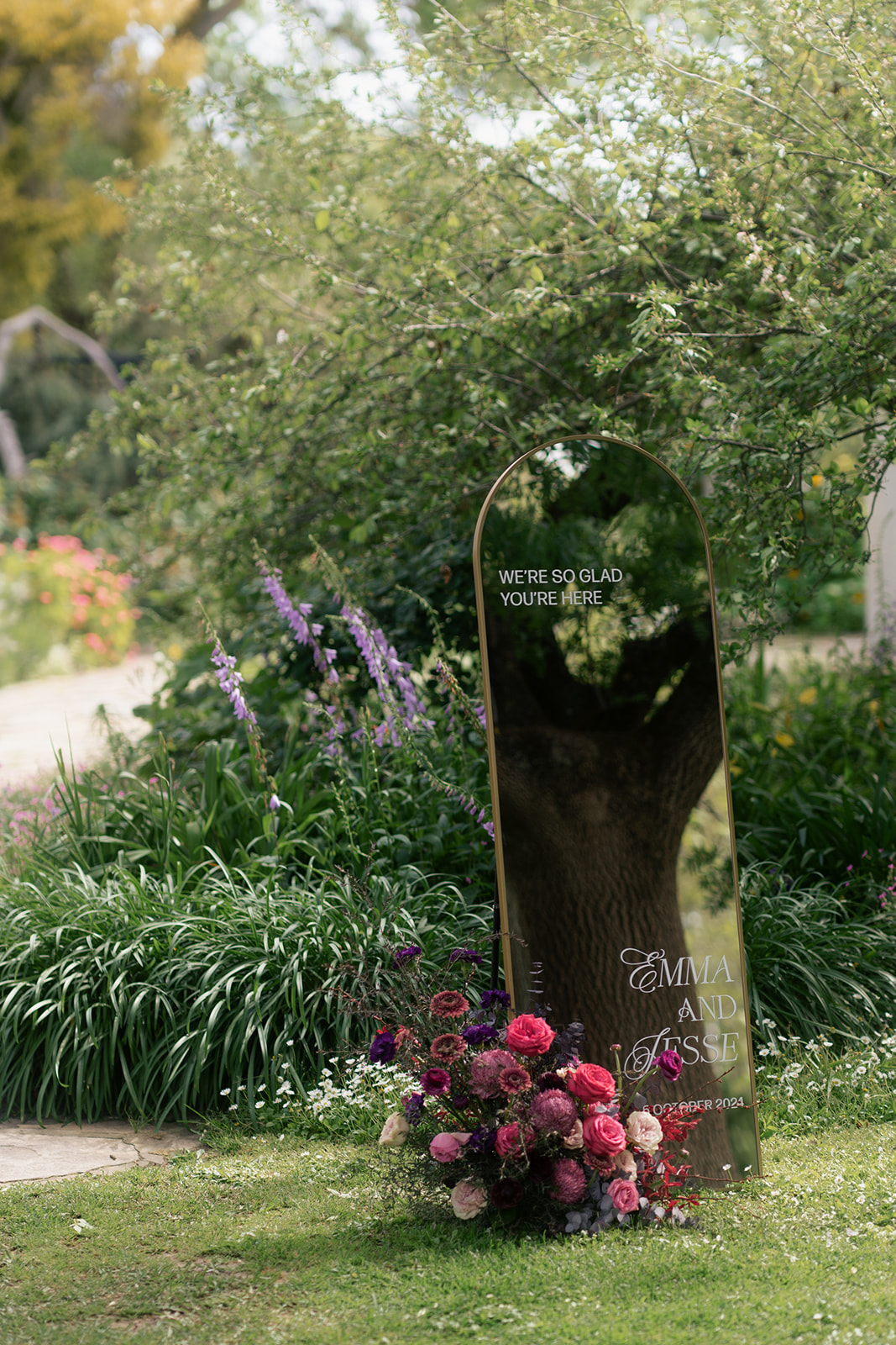 Mirror in Al Ru Farm garden, with bride and grooms name and flowers to suit moody rustic elegance theme