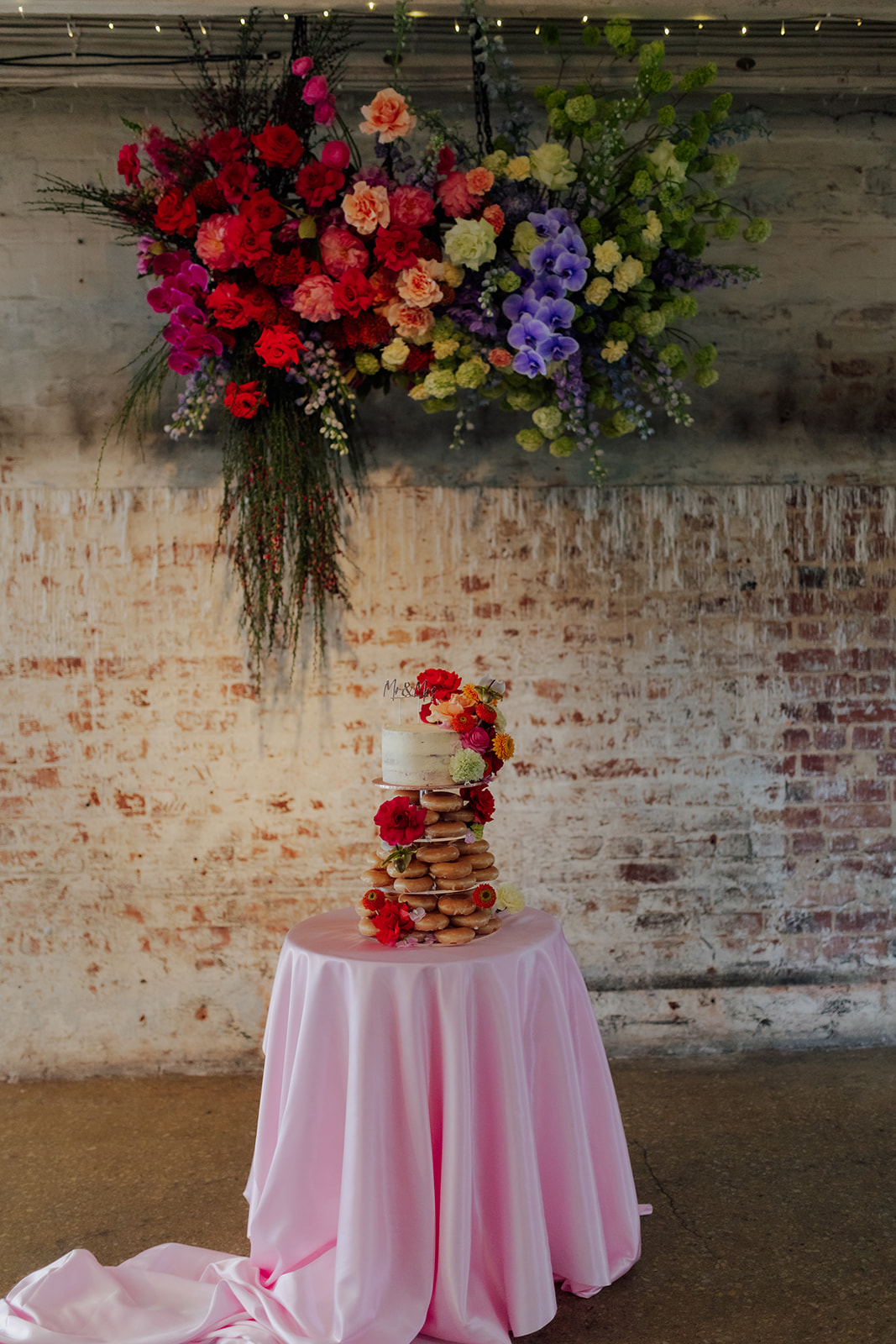Wedding cake and hanging floral installation at Intimate wedding infused with fun and colour