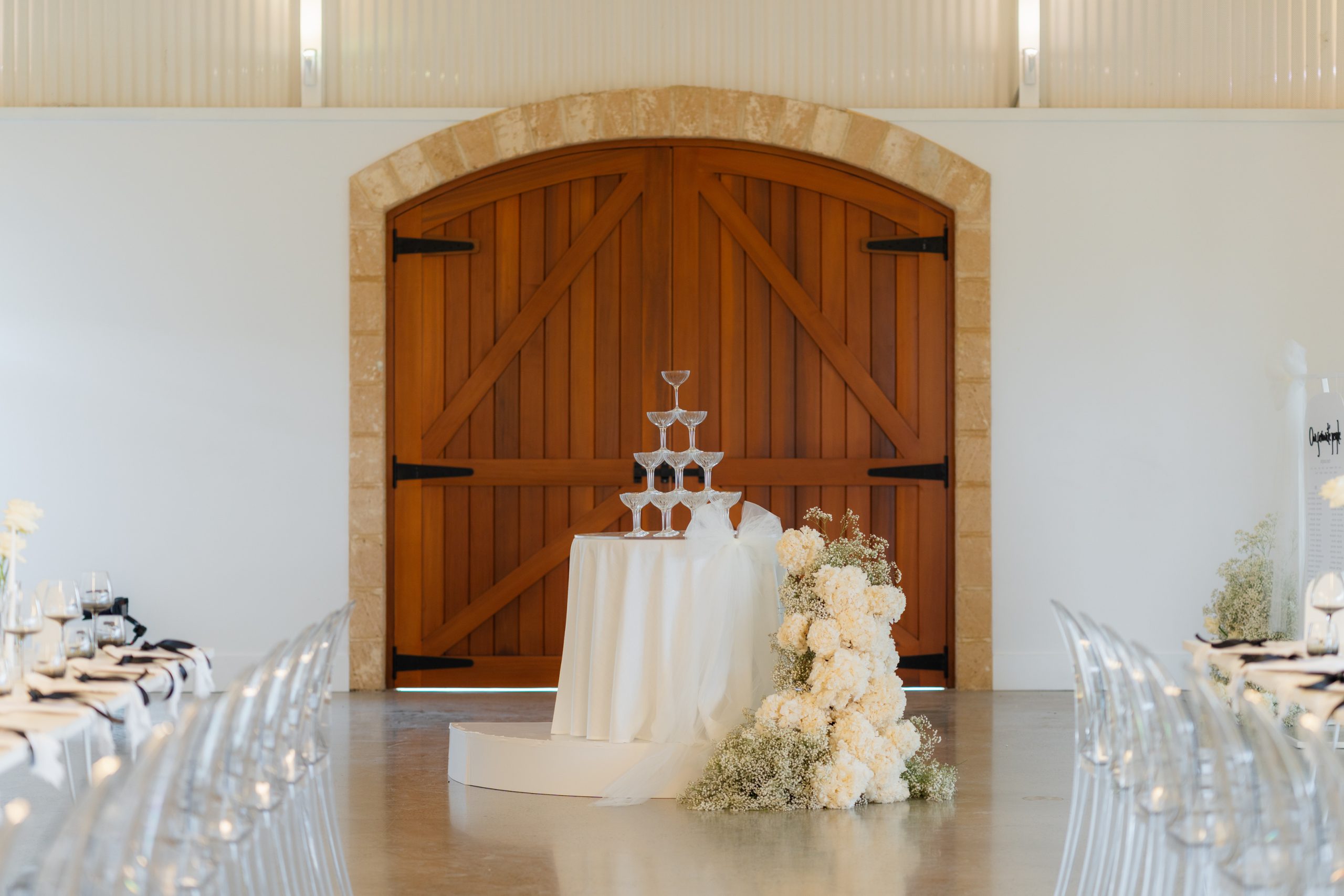 Classic black and white wedding champagne tower styled with white draping fabric at Lloyd Brothers winery