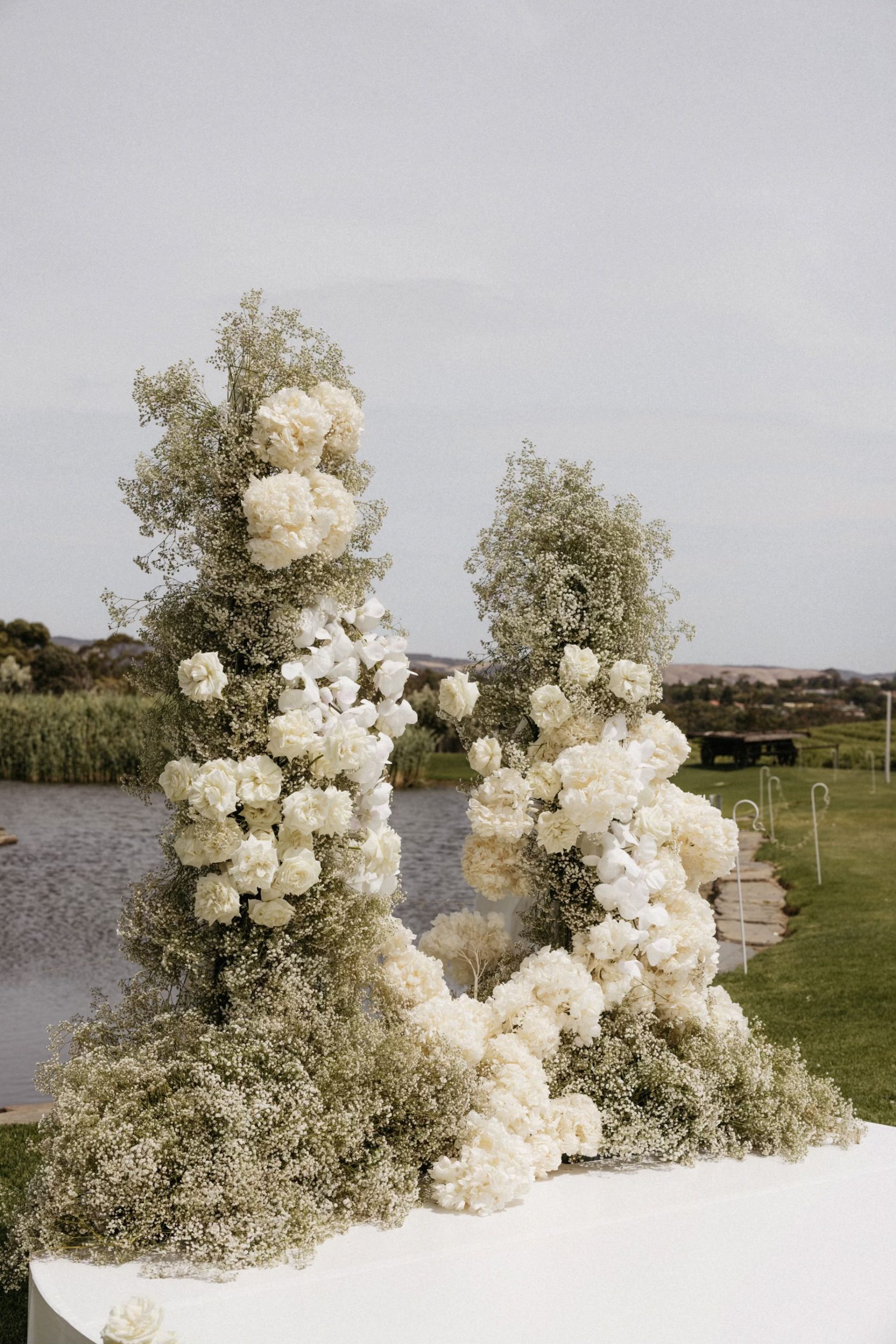 Classic black and white large floral arrangement for white arbor creating a dream adelaide winery wedding