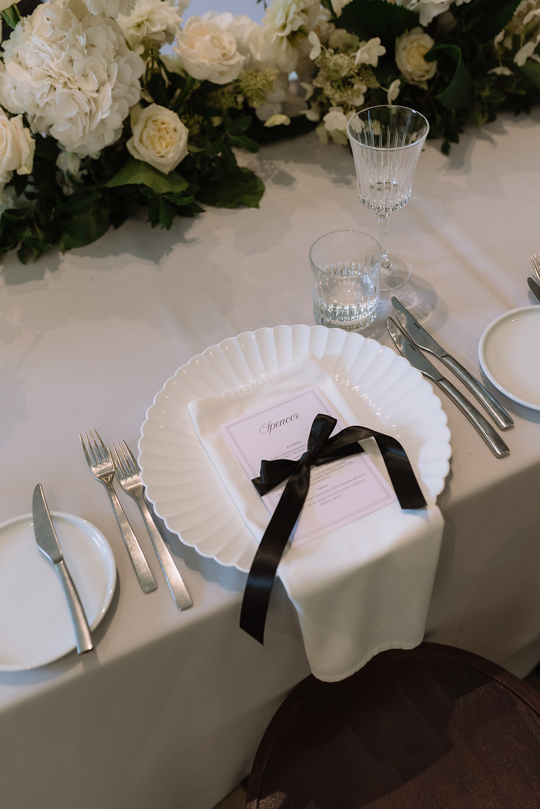 monochrome luxe garden party wedding design with bows throughout the styling