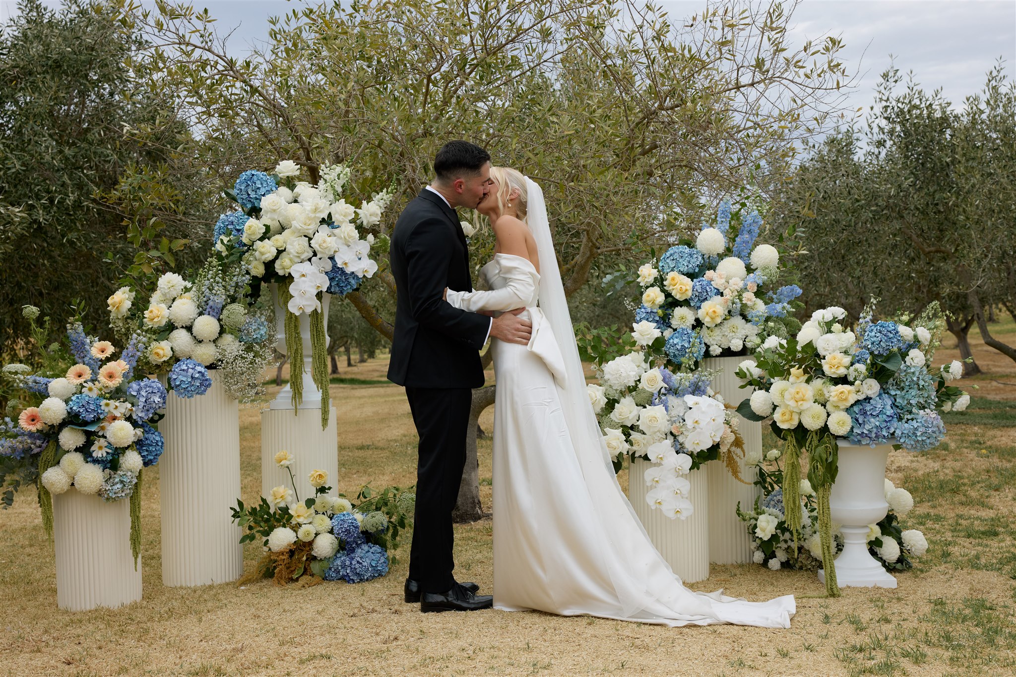 Wedding at Lloyd Brothers Winery with European summer garden vibe featuring blue and white flowers in amongst olive grove