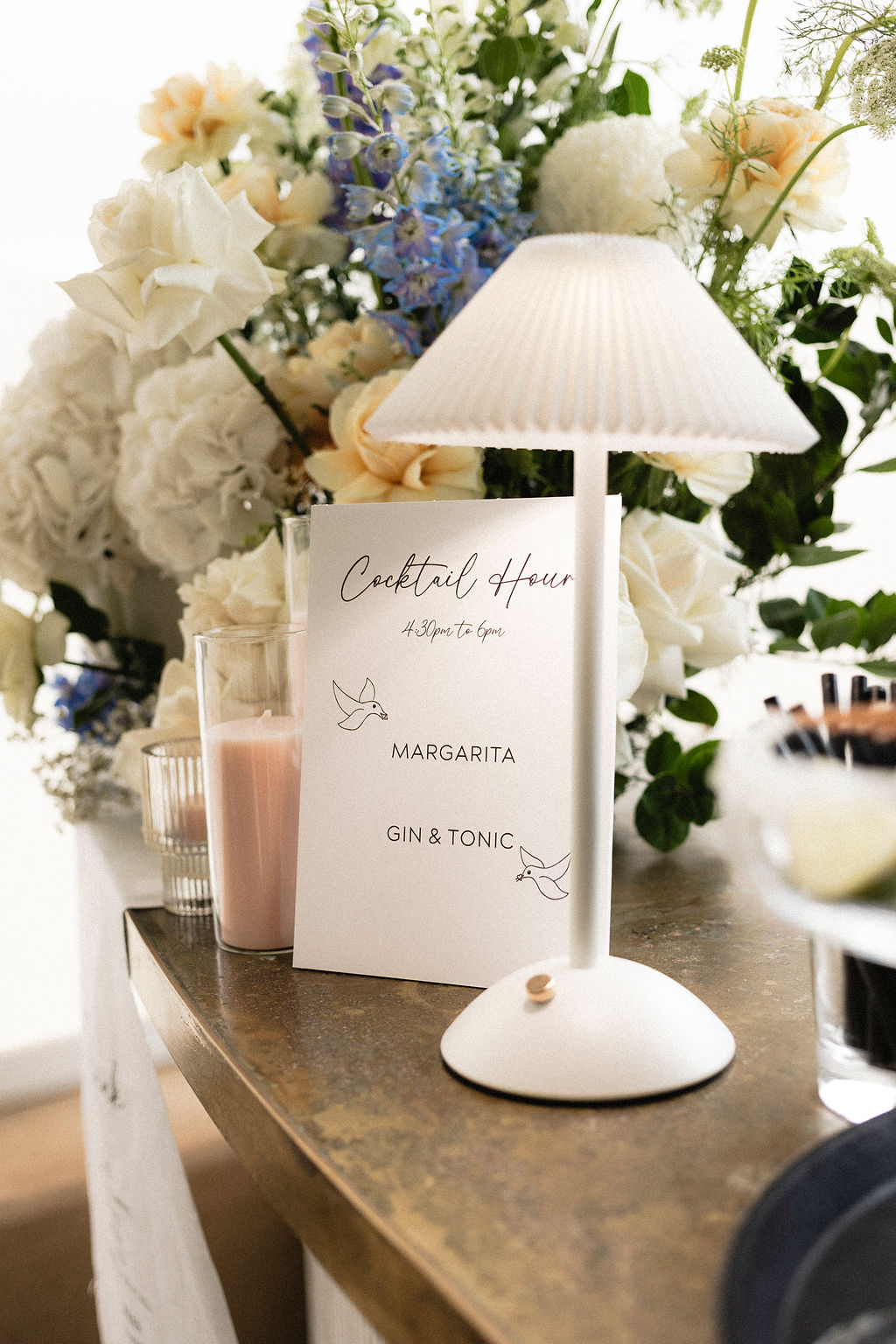 Cocktail hour sign and bar lighting and floral arrangement styled by The Modern Approach at Lloyd Brothers Winery. Photographed by Tash Mohring