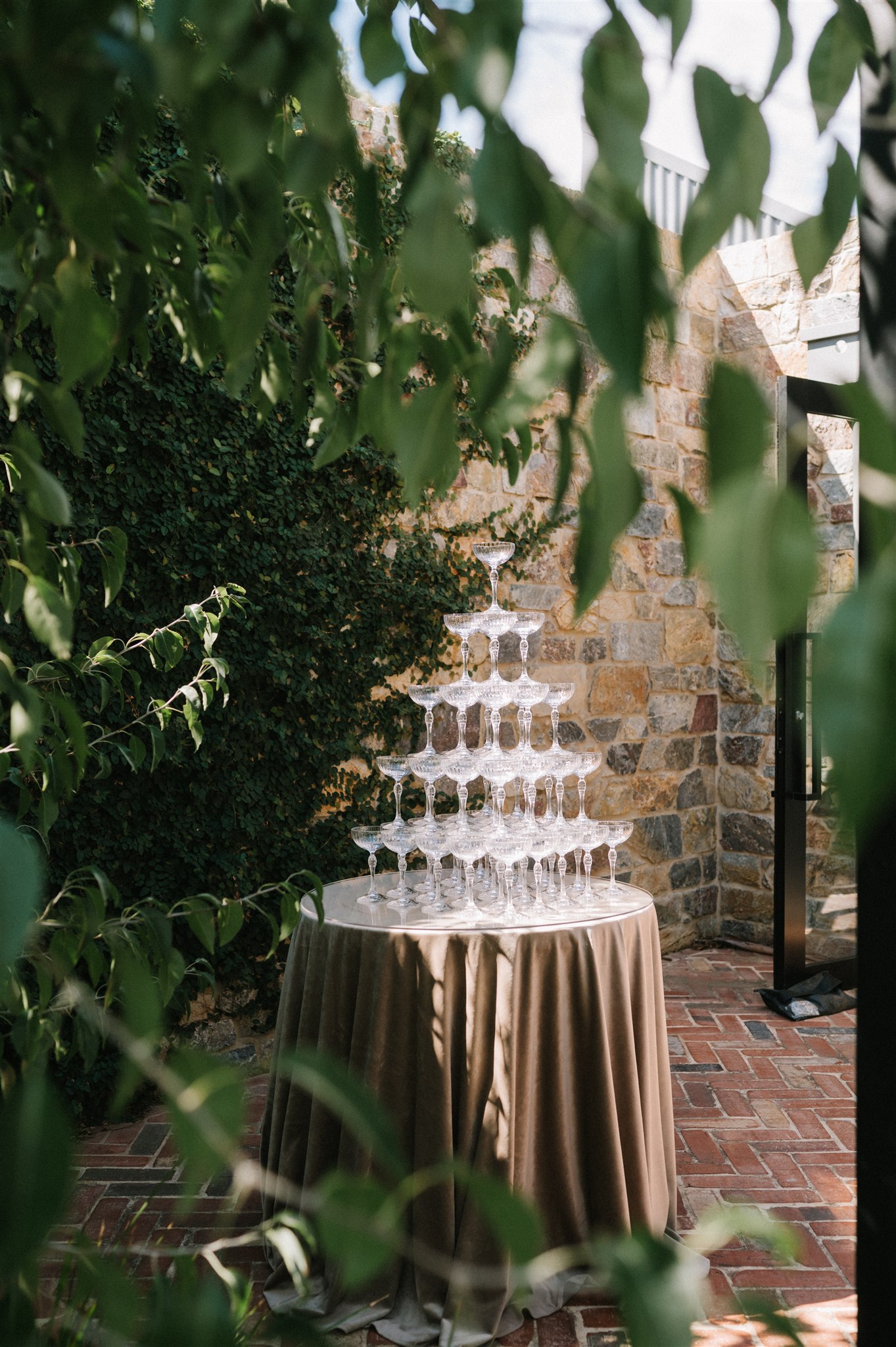 Champagne tower set up on round table in garden court yard