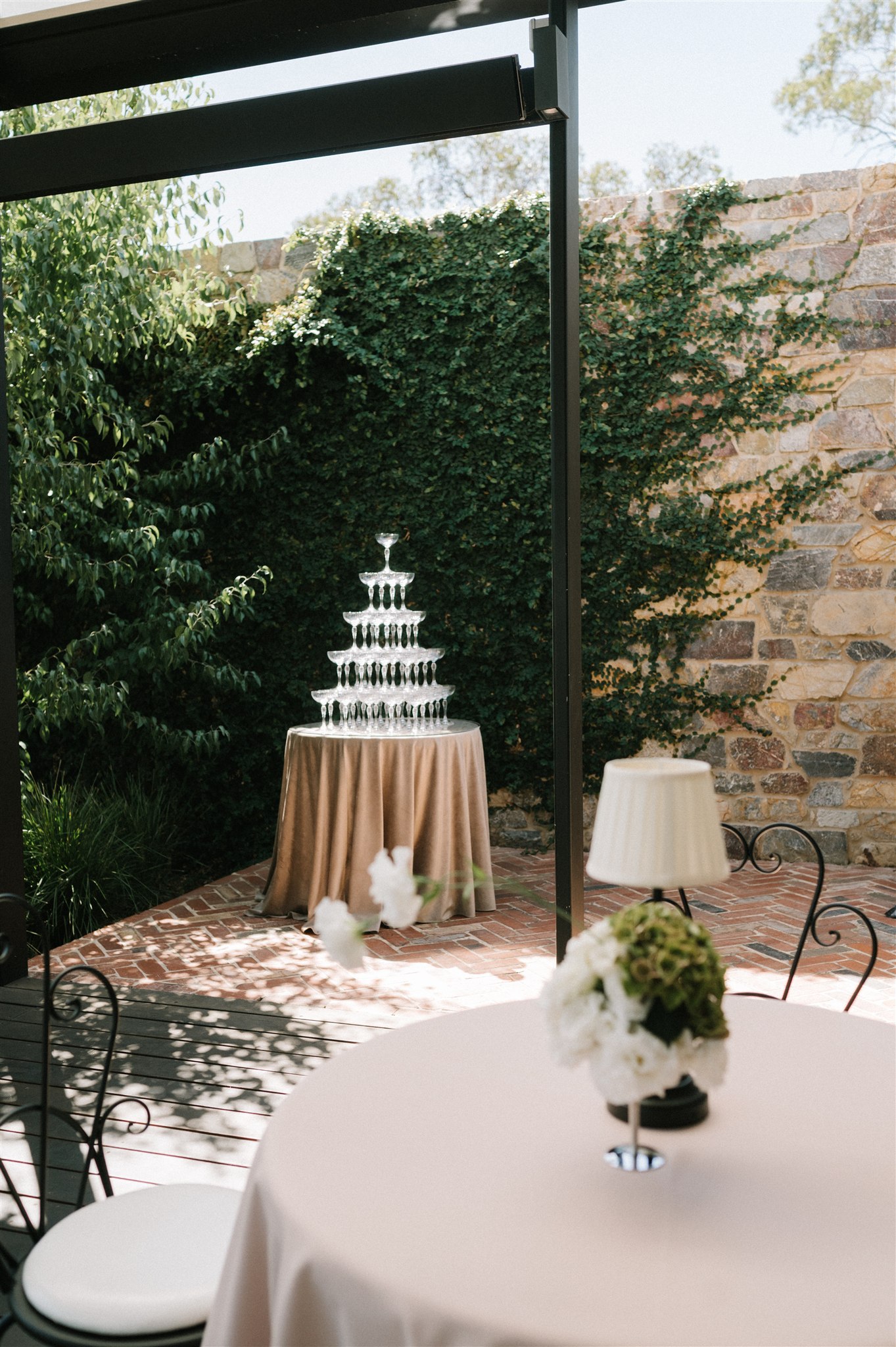 Champagne tower set up in garden courtyard wedding reception at house on haines