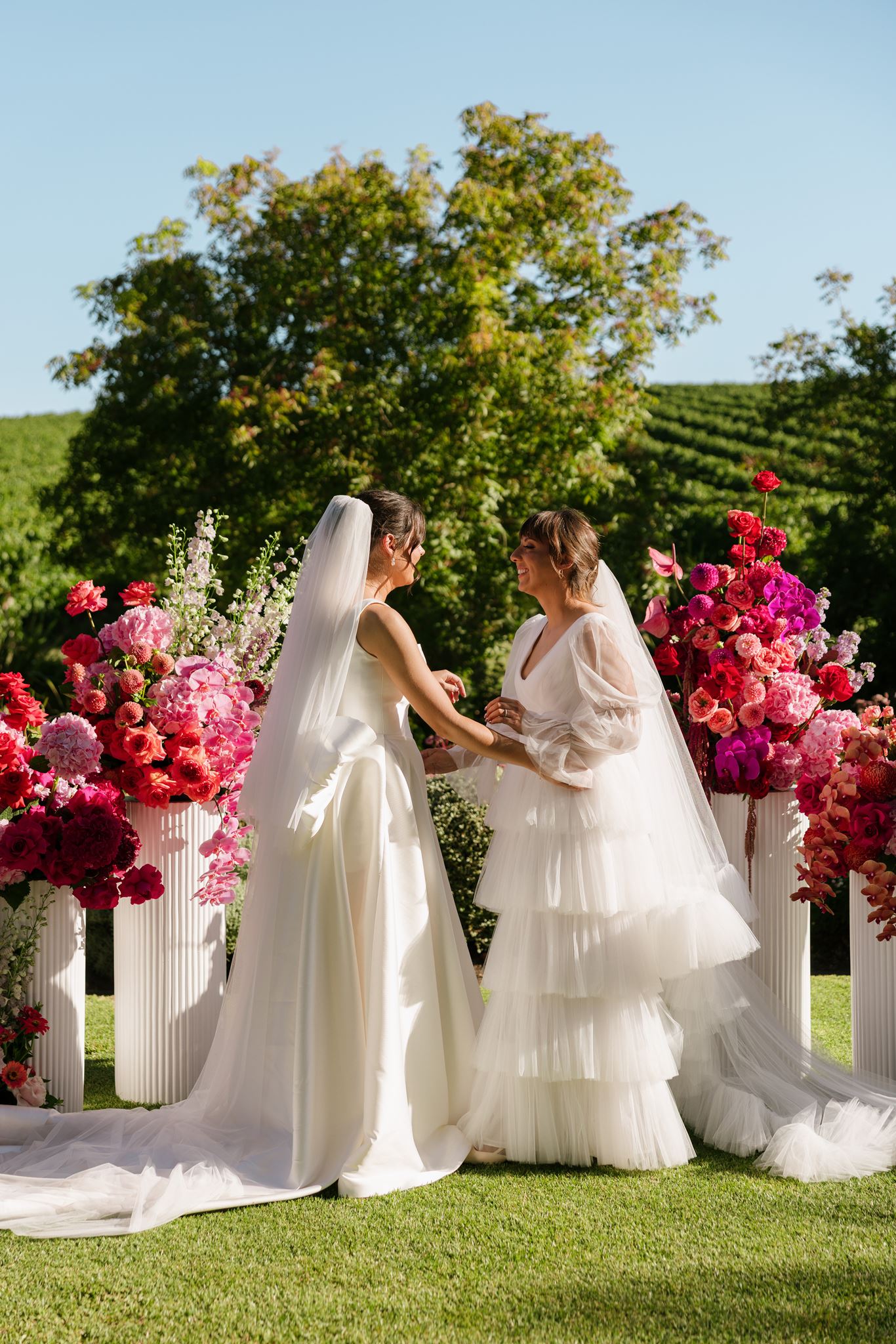 Brides in front of ceremony floor arbour at Colourful Wedding Styling at Goldings Winery Adelaide