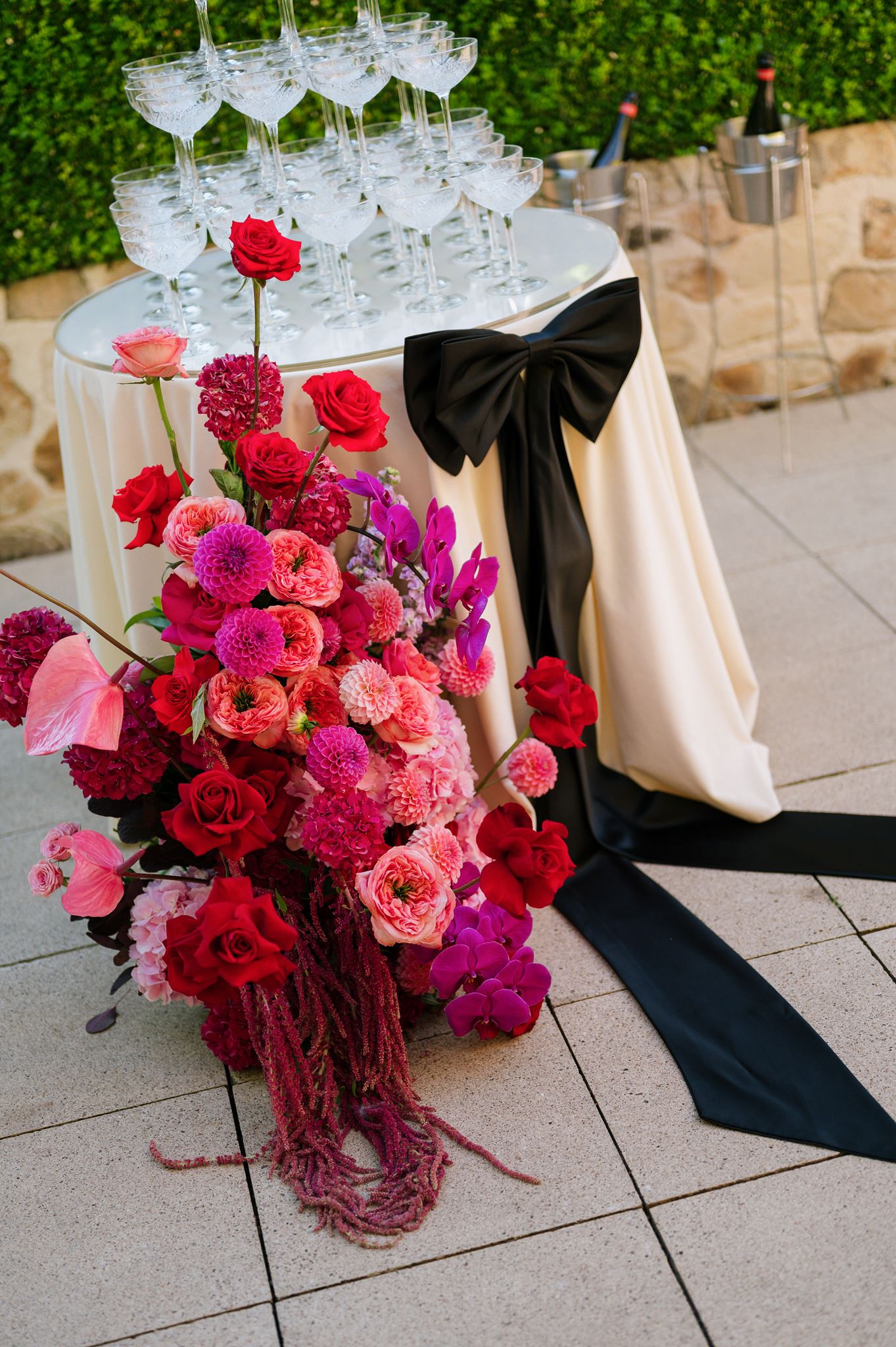 Floral floor boquet infront of champagne tower with large black bow Colourful Wedding Styling at Goldings Winery Adelaide