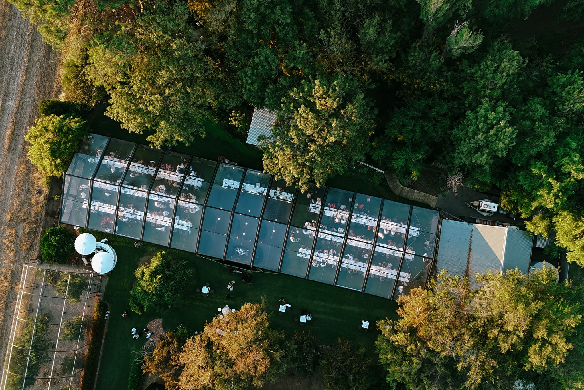 Drone photo shot from directly above clear roof marquee wedding reception at Whites Valley estate