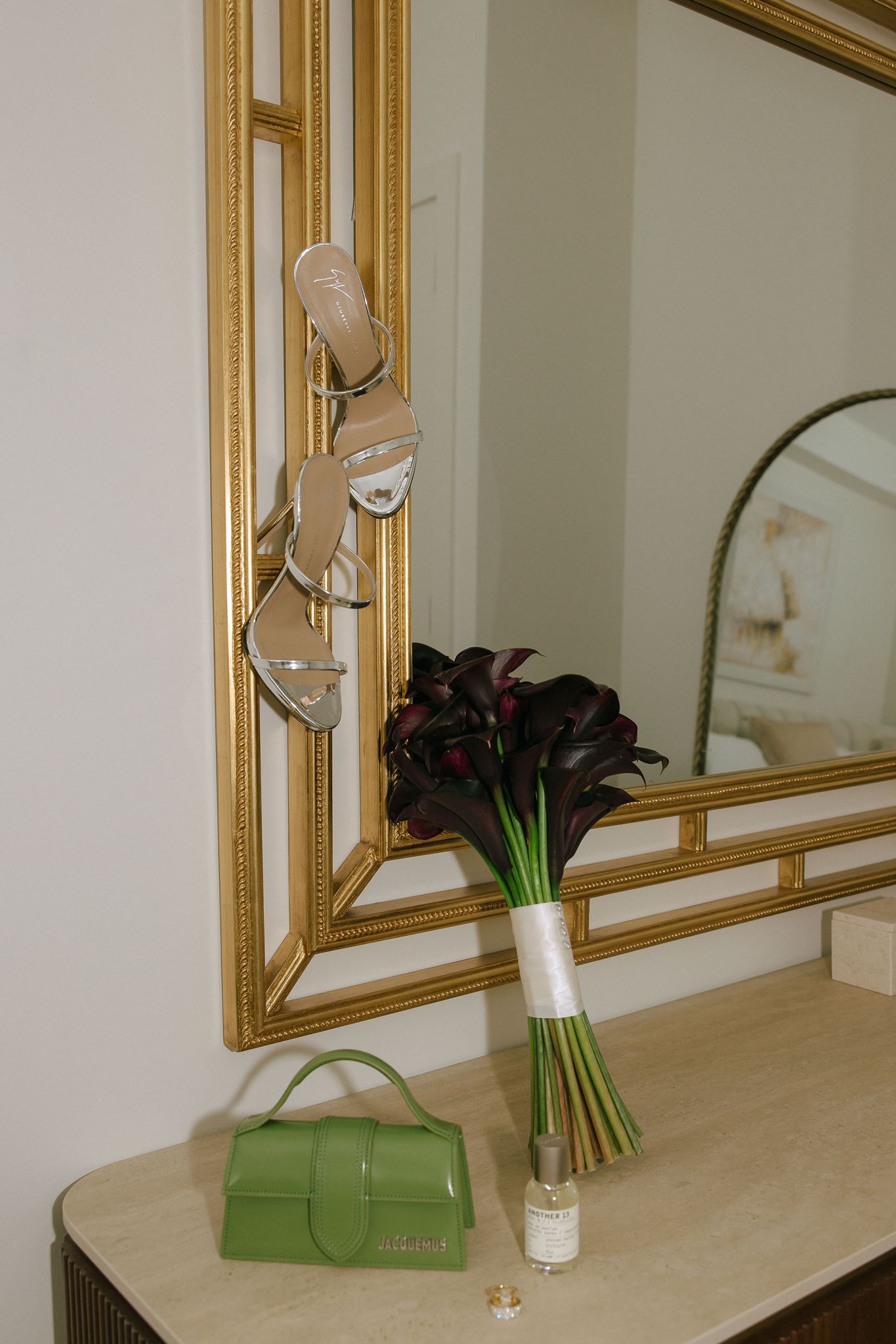 Bridal bouquet and shoes displayed on gold mirror