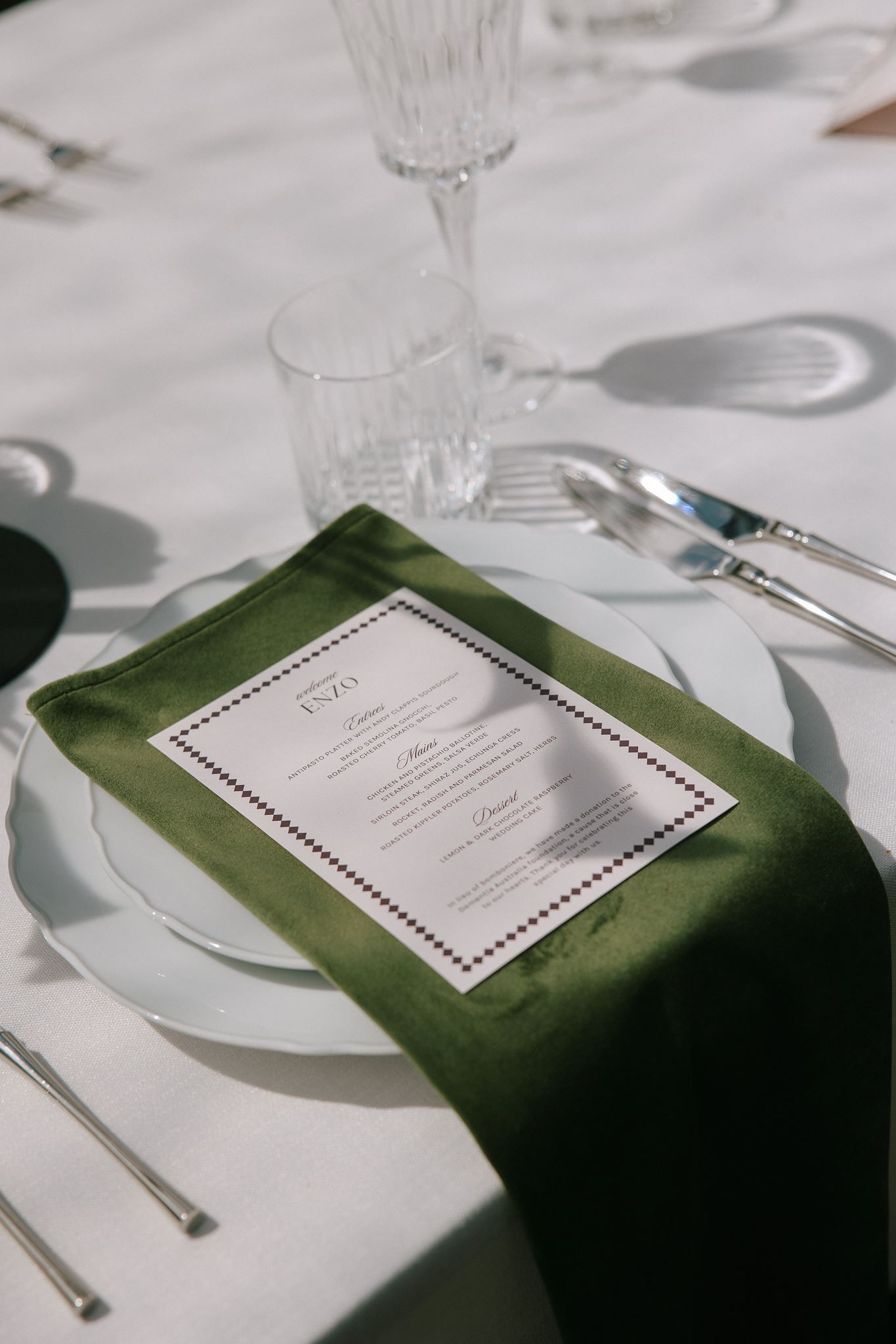 Close up on wedding reception menu on rich green velvet napkin