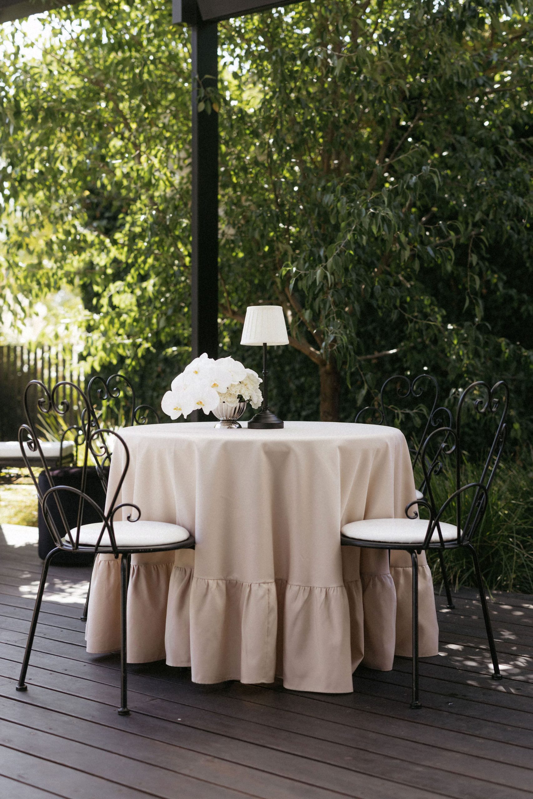 Garden setting with draped fabric and white flowers in House on Haines wedding reception area