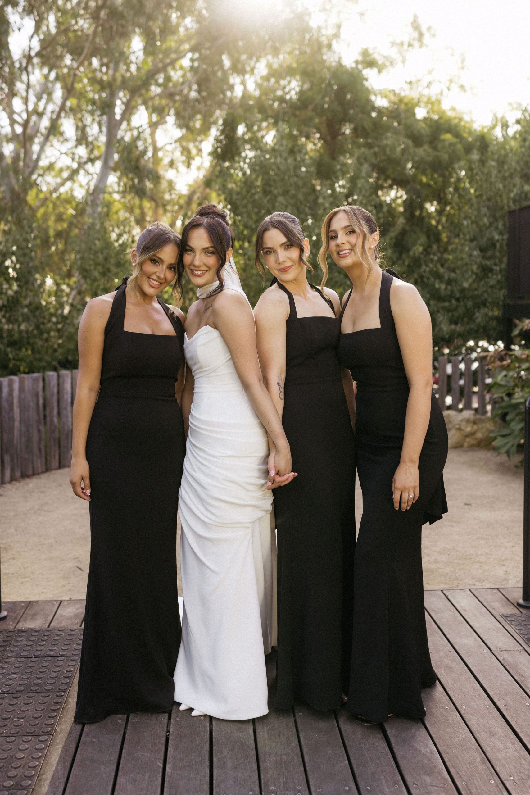 Bridal party posing for photo on deck of House on Haines