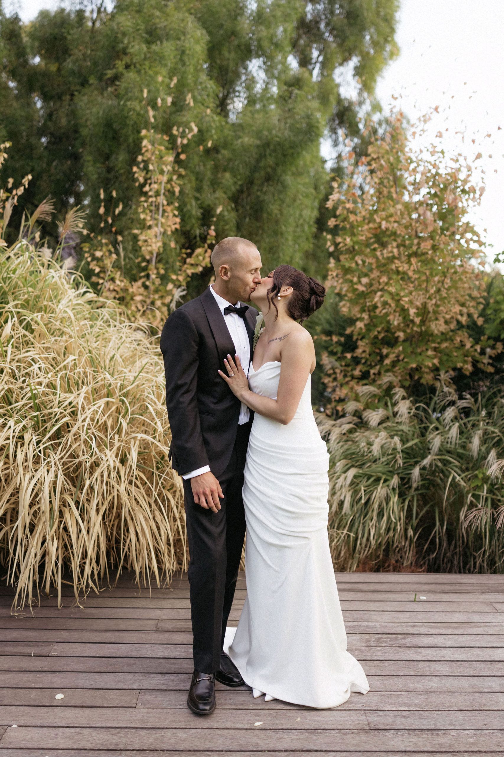 Bride and groom kissing on deck at House on Haines, Adelaide Foothills
