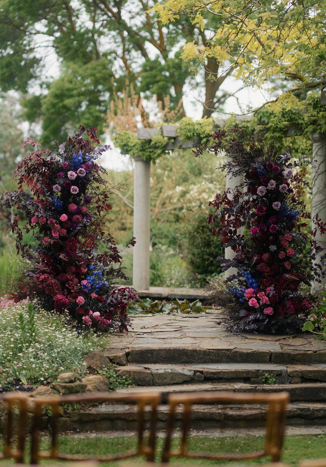 Wedding Arbour made with florals that create a moody rustic elegance