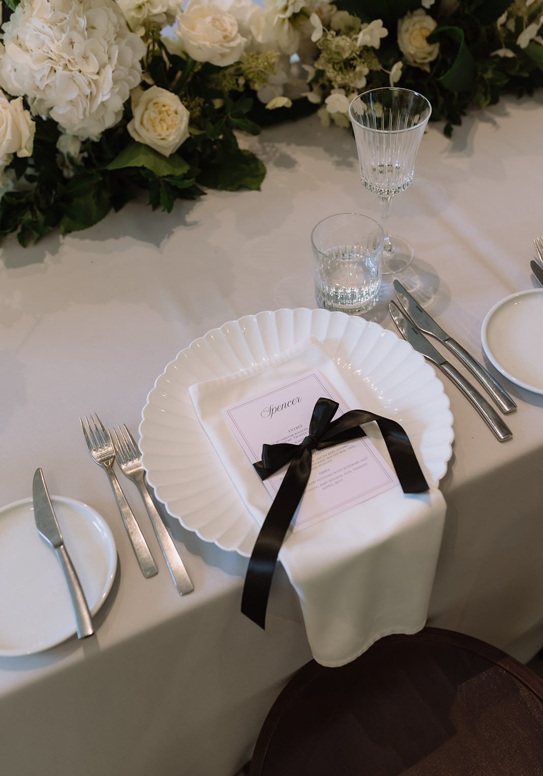 monochrome luxe garden party wedding design with bows throughout the styling